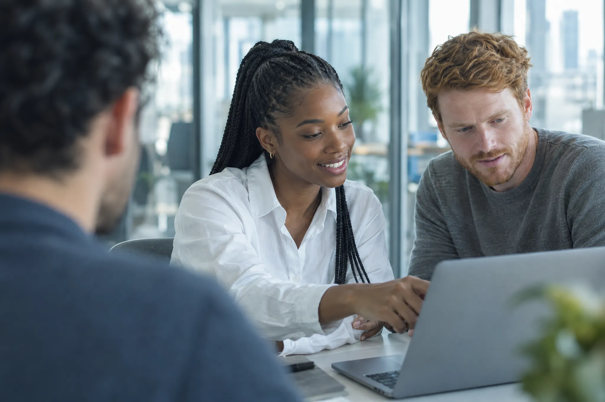 Two people from the Aevus team walking a client through a workflow on a laptop
